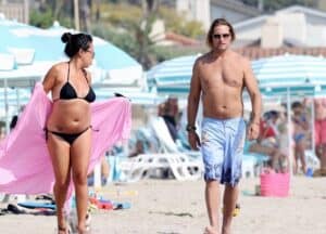 Yessica Kumaka with her husband Josh Holloway walking in a beach.
