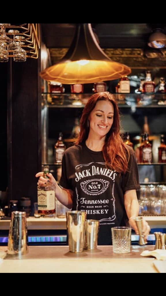 Mia Mastroianni as a bartender