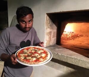 Aziz Ansari poses with his pizza