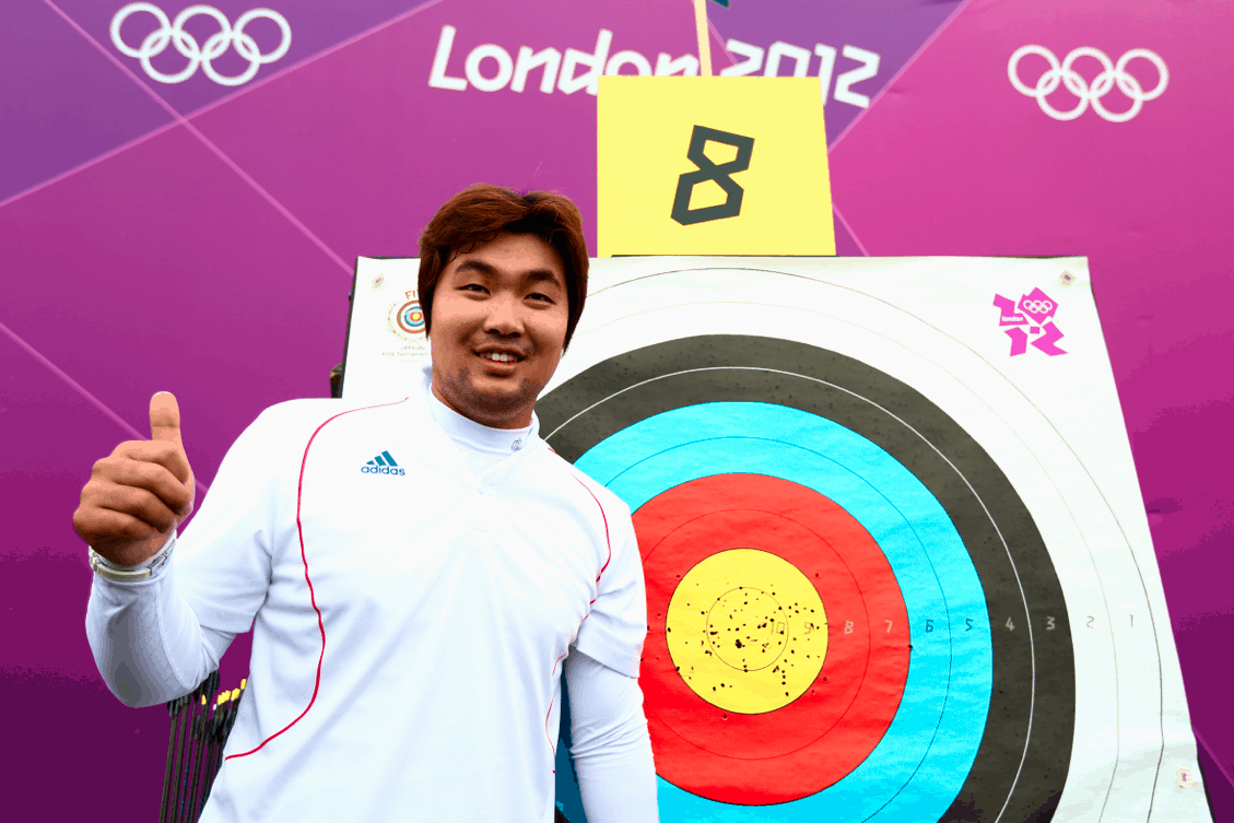 Im Dong Hyun Standing Next to archery point board