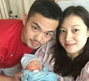 Lin and his wife with their new born child