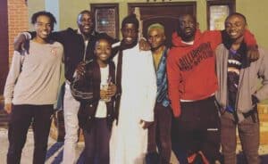 Akon posing with dad, brother and kids.