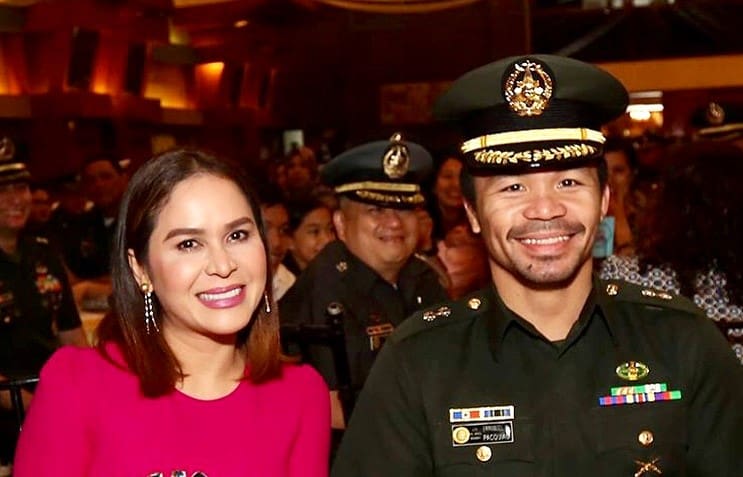 Manny Pacquiao during a military ceremony with his wife