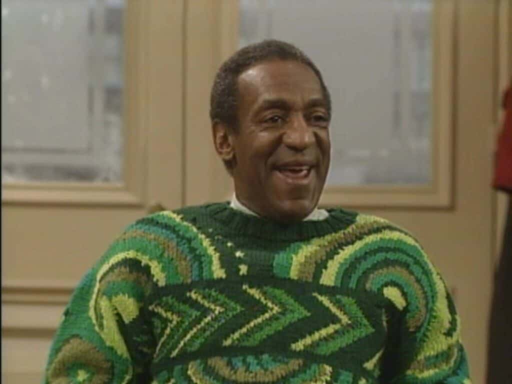 Bill Cosby wearing an iconic sweater in a still from 