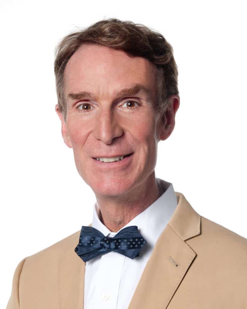 Bill Nye is Smiling to Camera.