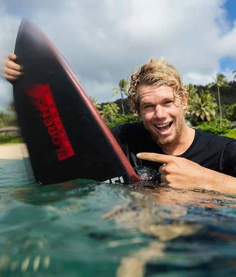 John Florence with his surfboard