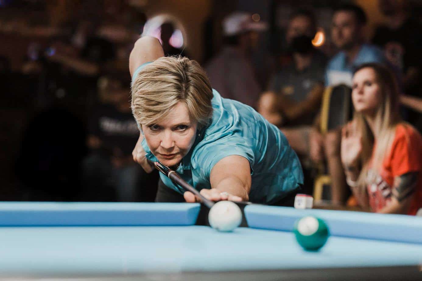 Allison Fisher focuses on a game of pool