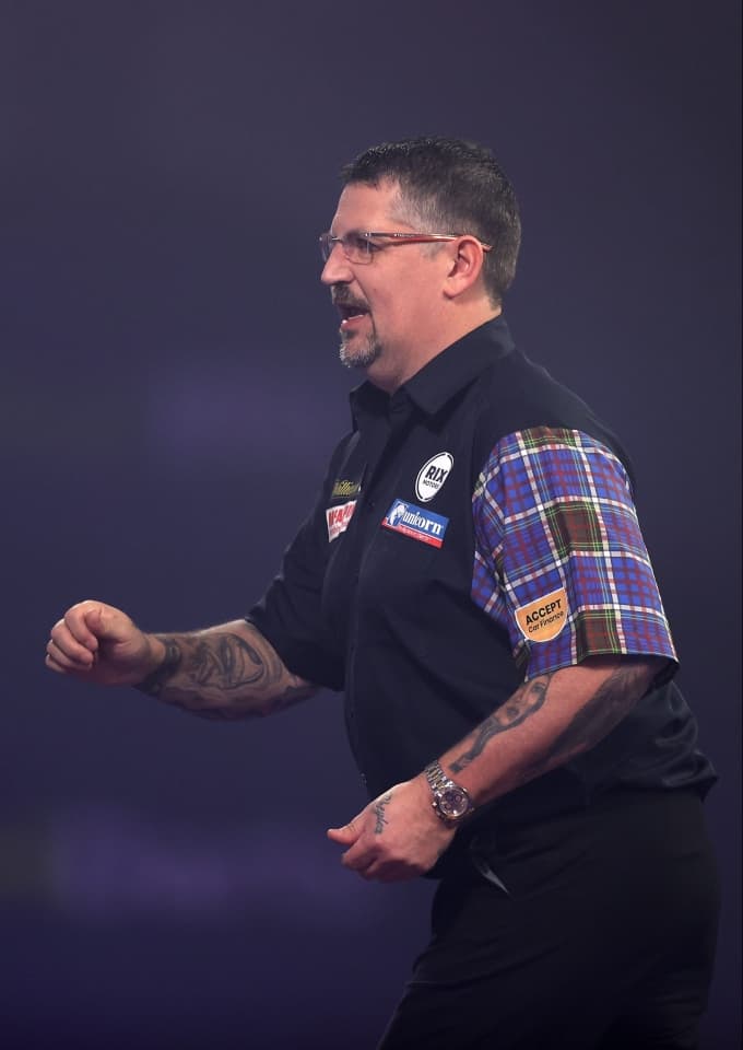 Anderson photographed after throwing a dart
