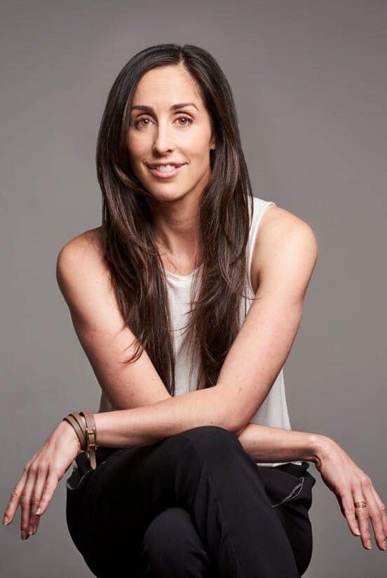Catherine reitman is smiling at the camera.