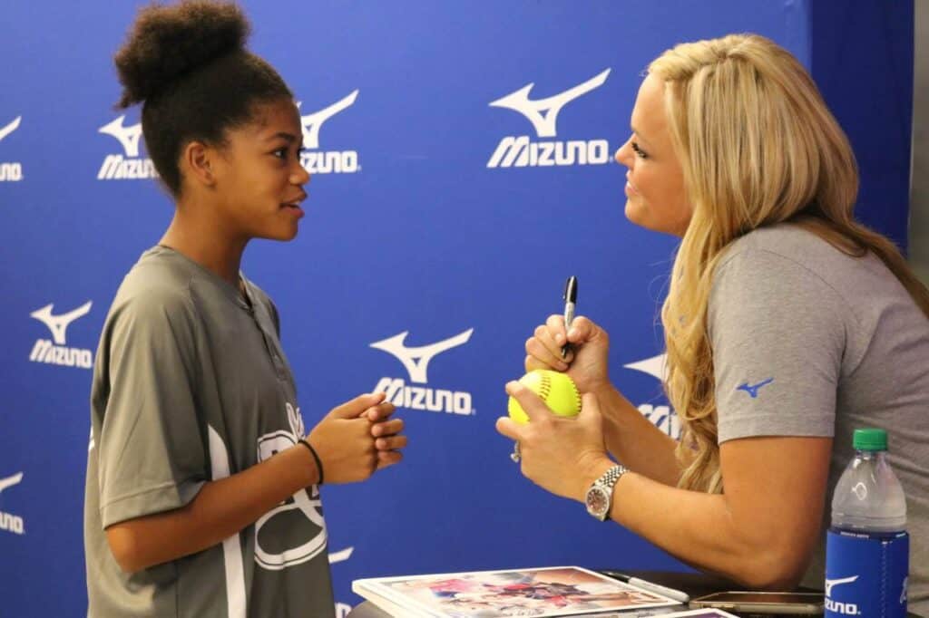 Jennie Finch autographs a fan's soft ball