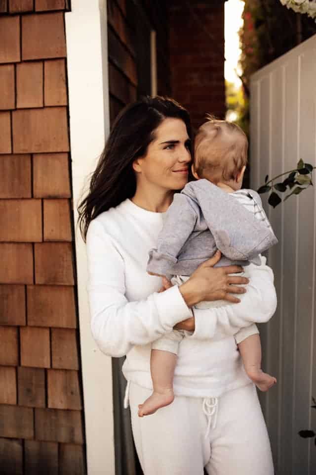Karla carrying her son
