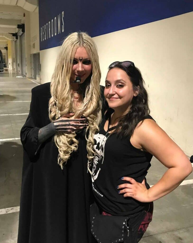 Maria Brink, who is full of tattoos, poses with a fan.