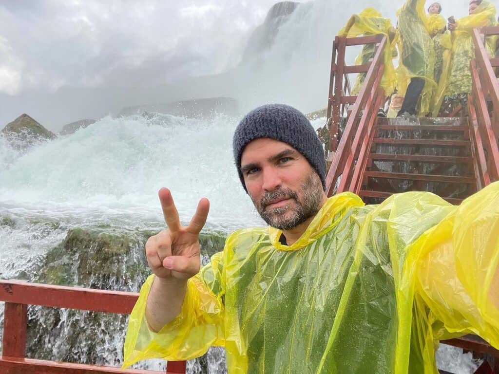 Eduardo loves to travel. He is posing for a photo in the infamous Niagara Falls.
