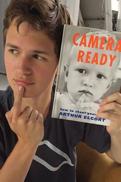 Ansel with a magazine with a childhood picture of himself.