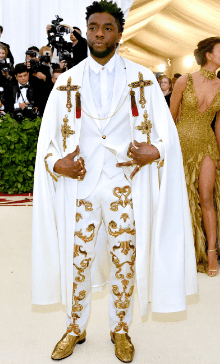 Chadwick Boseman in a catholic Versace outfit (Source: allure)
