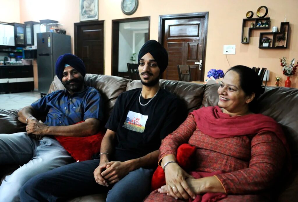 Arshadeep Singh with his parents giving an interview.
